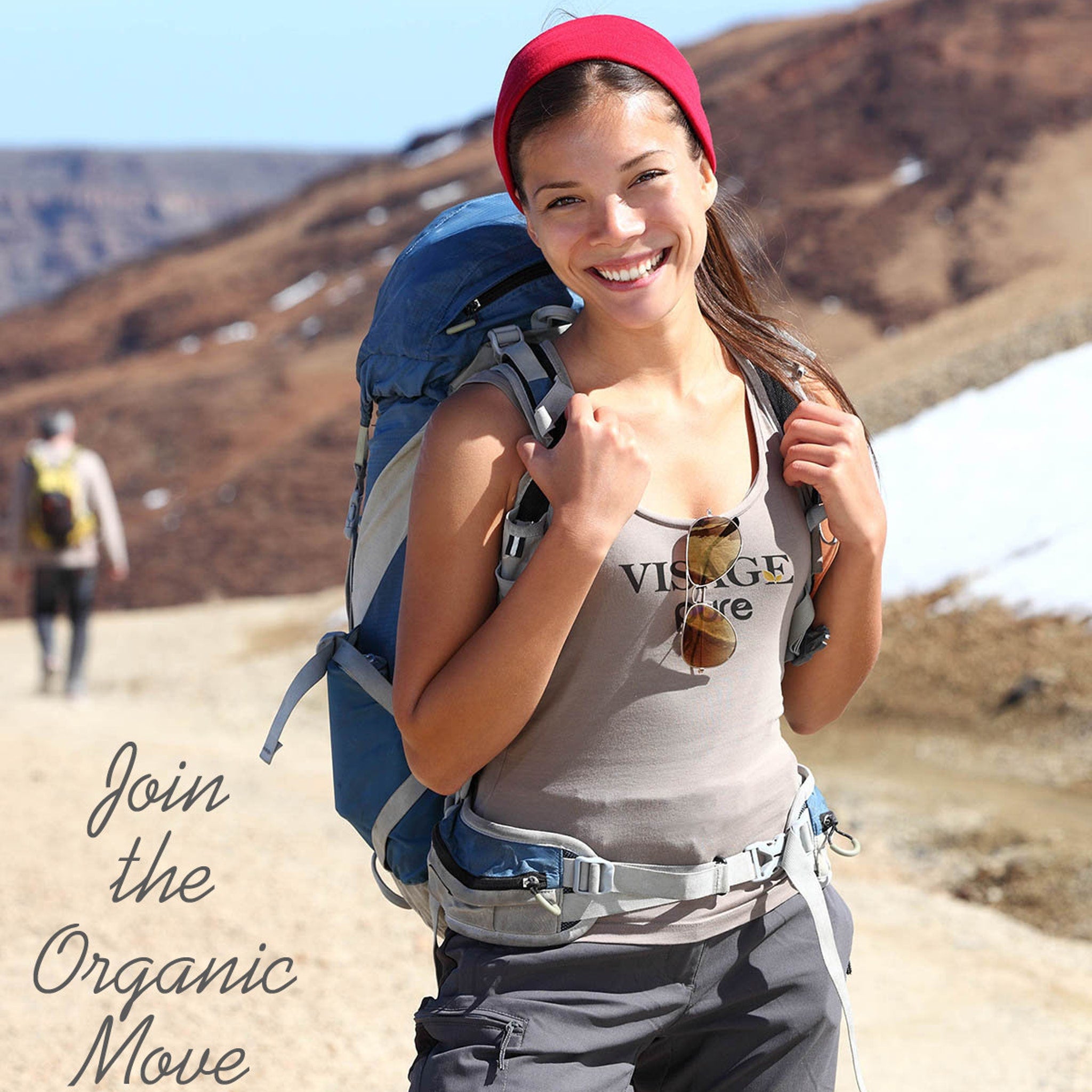 Hiking backpack with blue and gray straps, red headband, and Visage shirt while hiking
