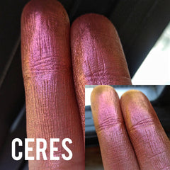 Hand applying NEBULA multichrome eyeshadow in chameleon orange-pink-gold-violet shift to eyelid