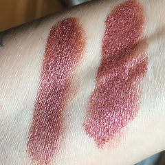 Side view of burgundy red raspberry vegan eyeshadow in sifter jar showing mineral luster texture