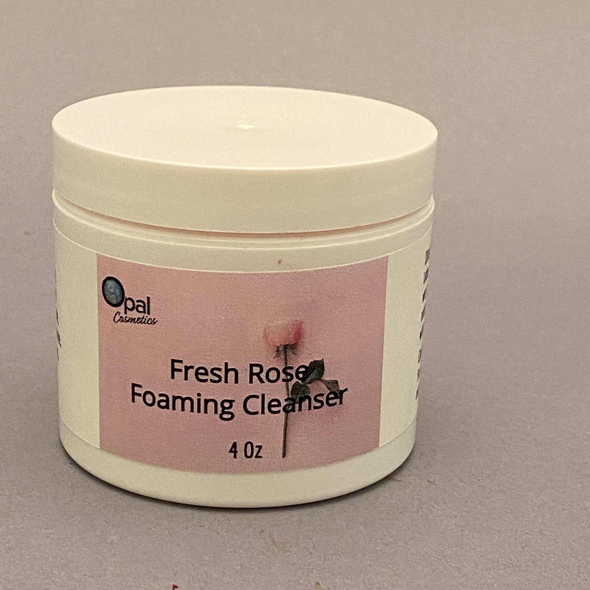 Foaming cleanser jar, off-white plastic, pink label with text and floral image, Opal Cosmetics brand