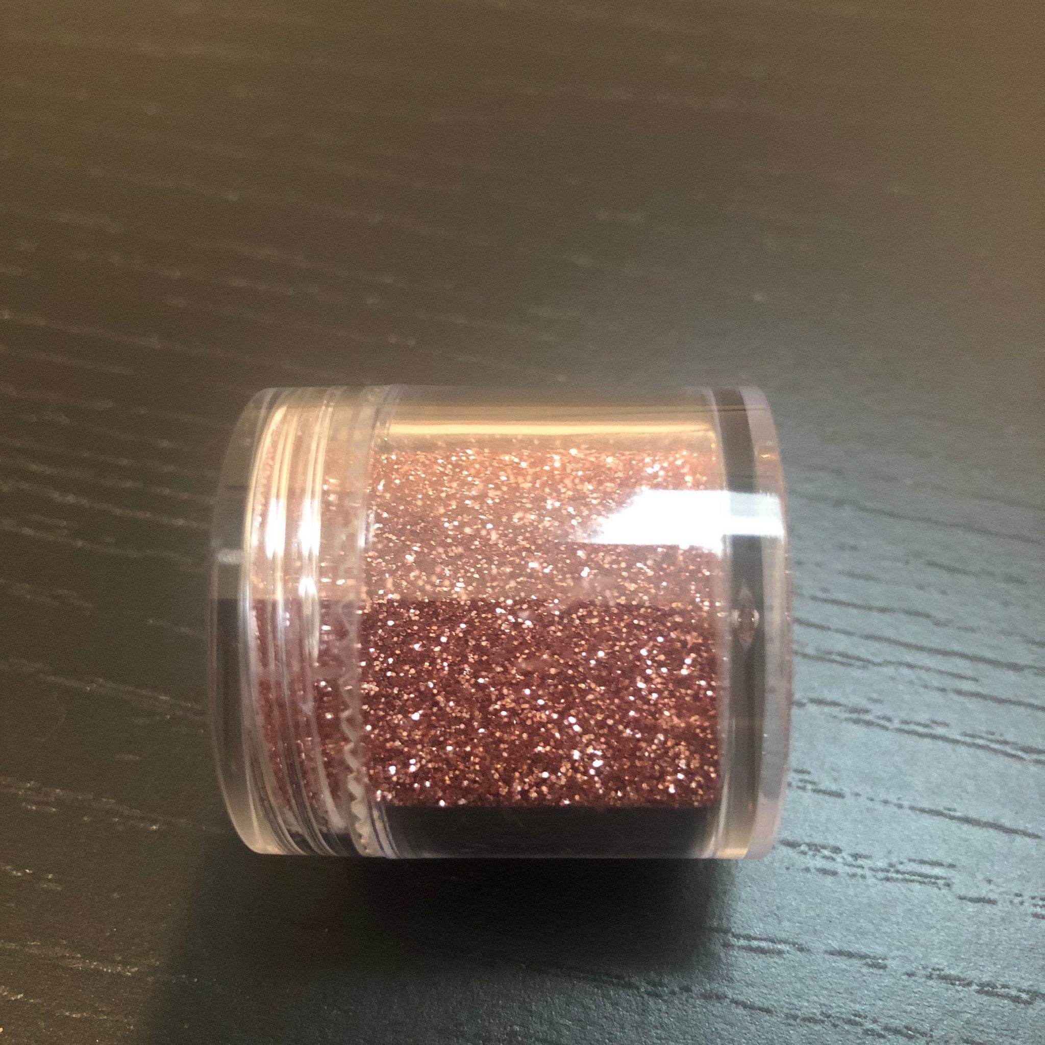 Close-up of shimmering rose gold eye shadow with metallic finish in compact palette