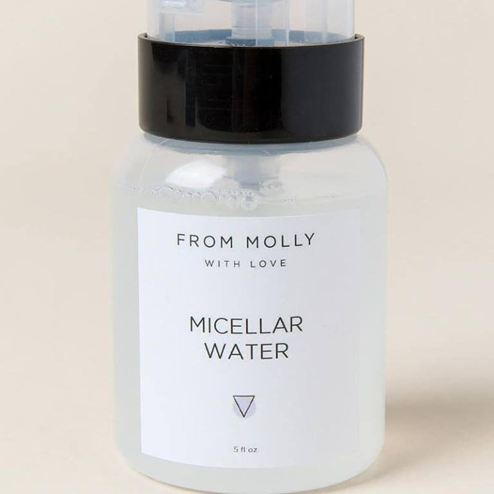 Micellar water bottle with black cap, clear plastic, and white label with text FROM MOLLY WITH LOVE