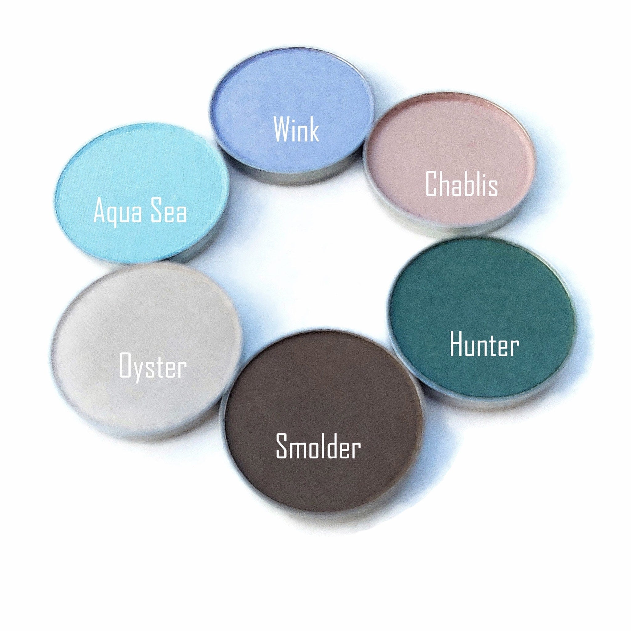 Eyeshadow palette with various colors, including blue, pink, and green, with text labels on each shade