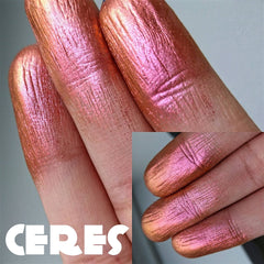Side angle of NEBULA multichrome eyeshadow pot showcasing orange-pink-gold-violet shift in natural light
