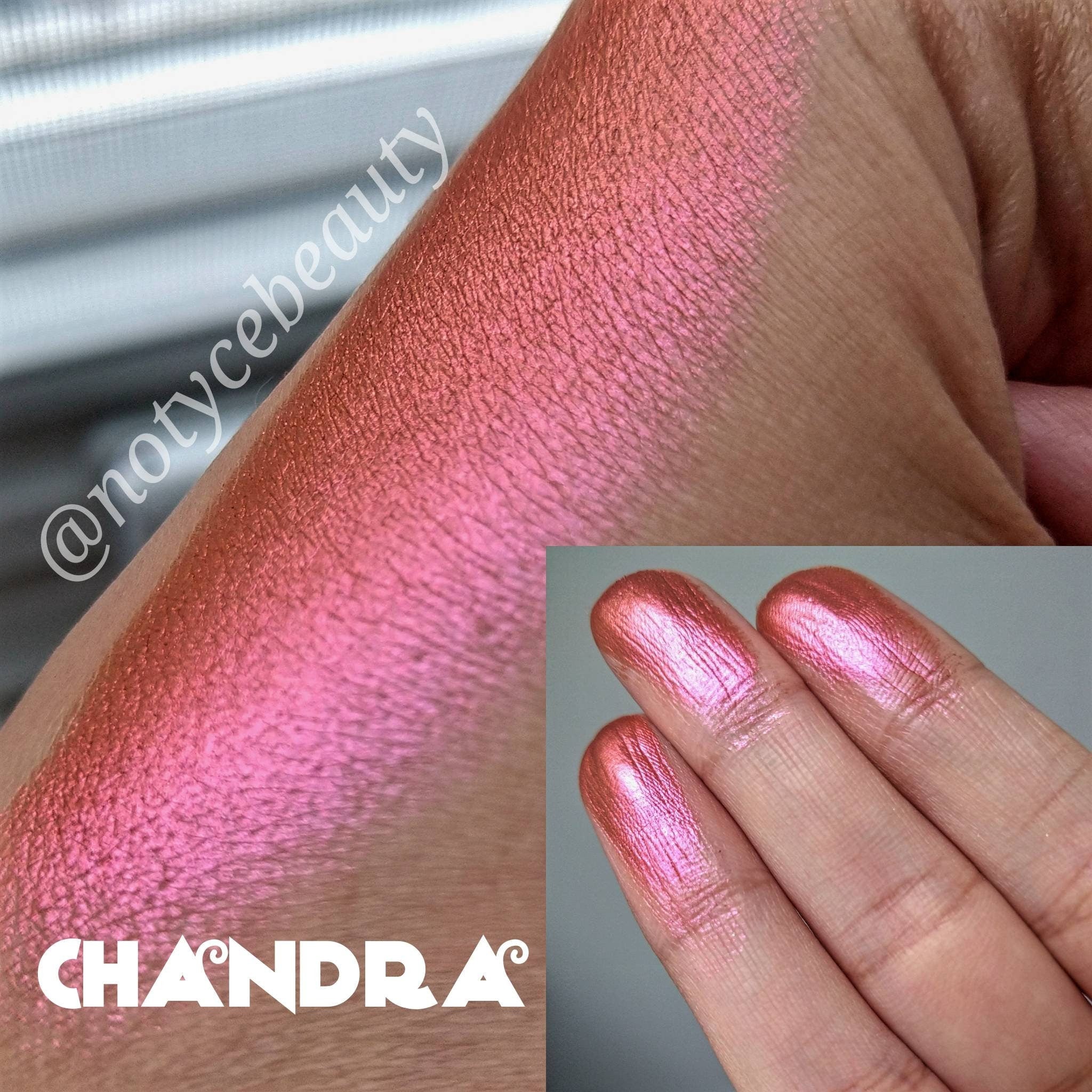 Open compact showing pressed multichrome eyeshadow pan shifting from dark orange to pink shimmer