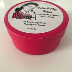 Dusting powder in a bright pink round container with Boho Betty Bliss label and Gardenia text