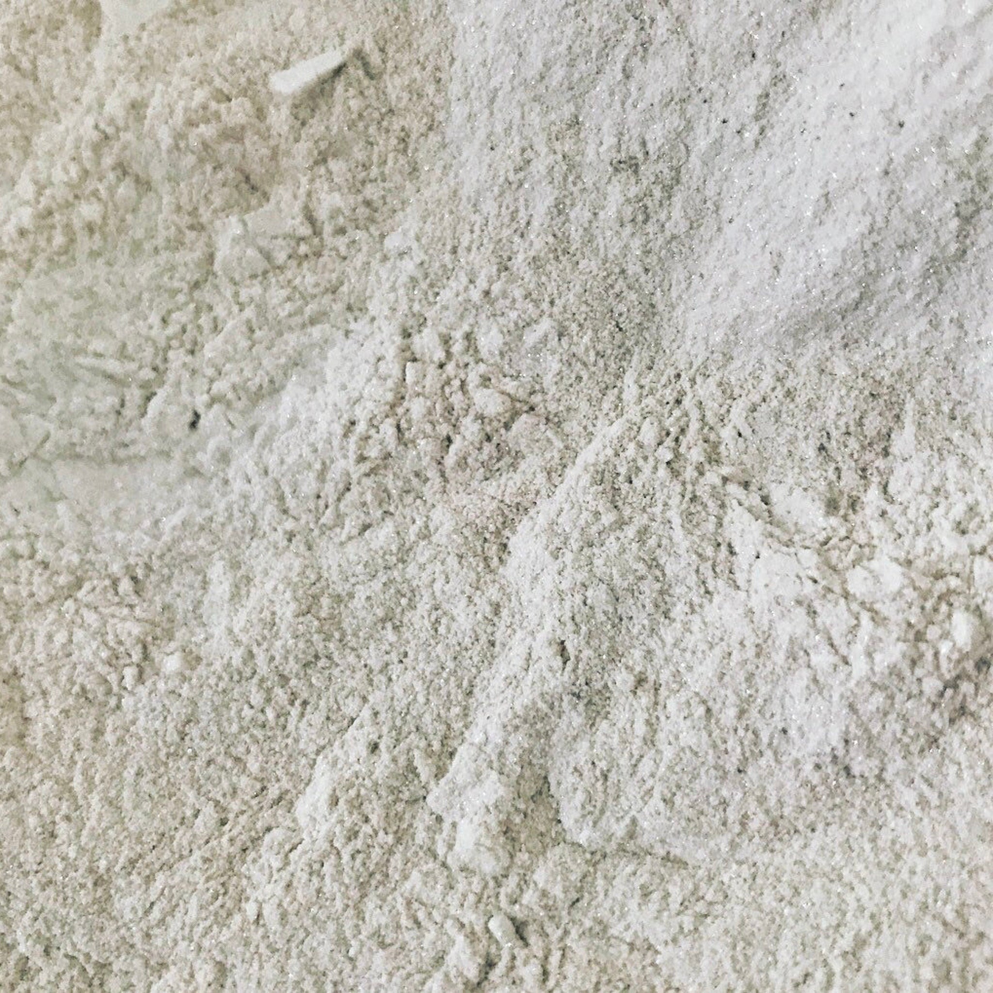 Powdered substance with white, textured, and granular appearance