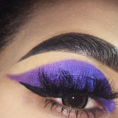 Close-up of Beauty Realm Purple Orchid vegan eyeshadow pan with rich violet shimmer in compact packaging