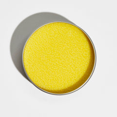 Yellow textured product inside a silver metal container on white background