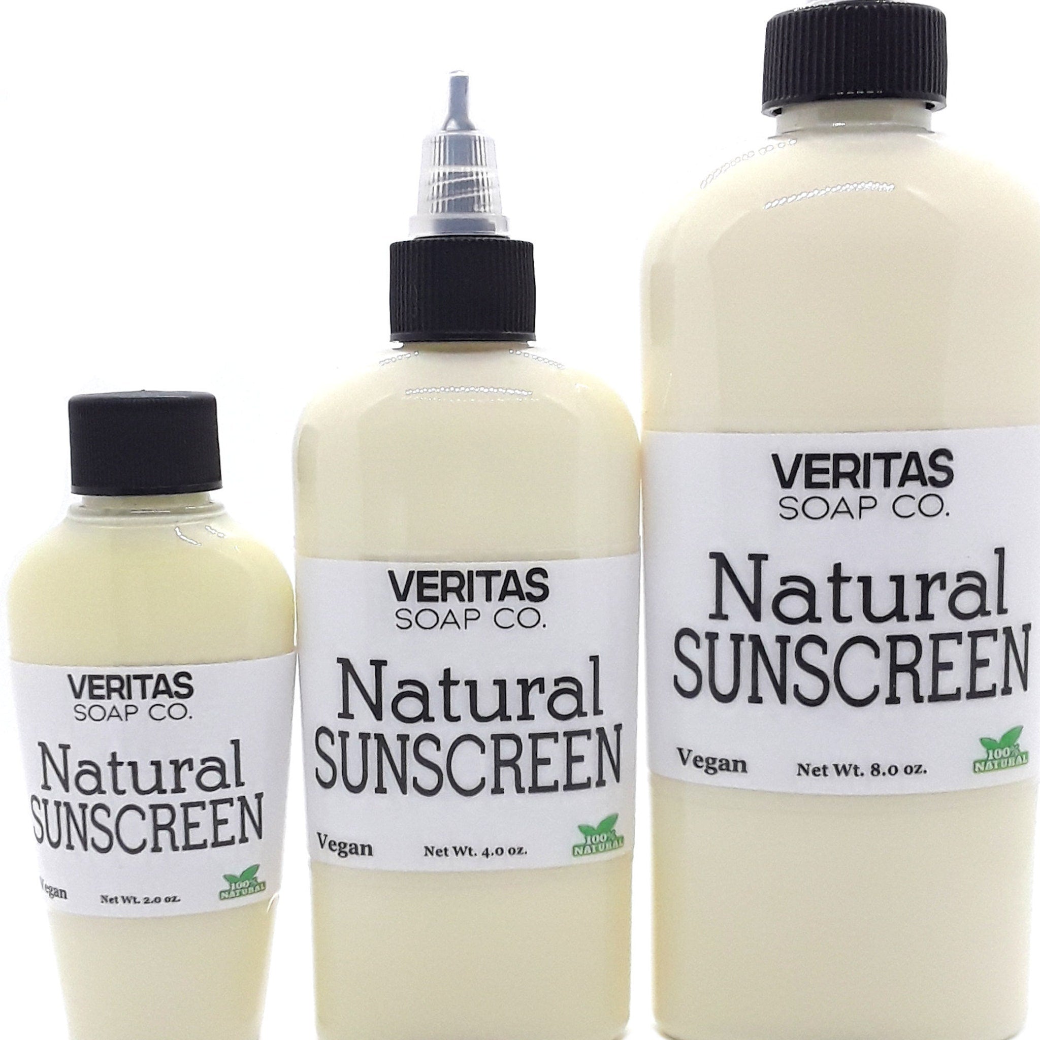 Natural sunscreen bottles in cream color with black caps and white labels, Veritas Soap Co. brand