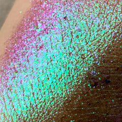 Hand applying shimmery pink Tala Foil Candy Eye Shadow Pigment to eyelid with fingertip