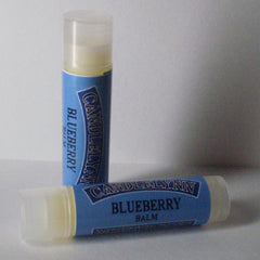 Lip balm tubes with blue labels and white caps, Candle Lynn Blueberry Balm visible