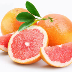 Grapefruit with orange skin and red flesh, with green leaves, cut and whole