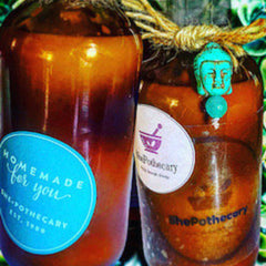 Brown glass bottles with turquoise Buddha charm and blue label, "Homemade for you" text