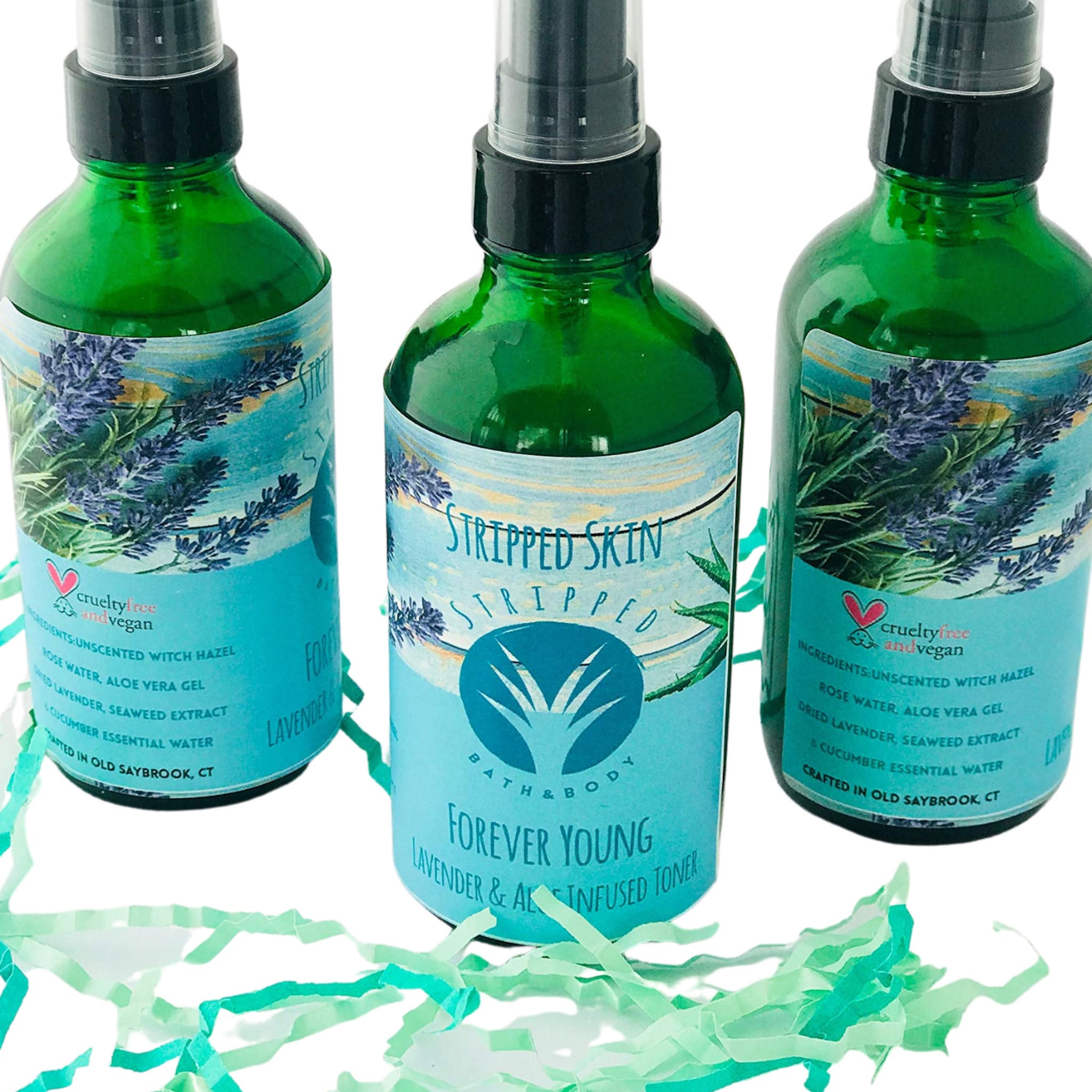 Toner bottles, green glass bottles with black spray tops and blue labels, Stripped Skin brand