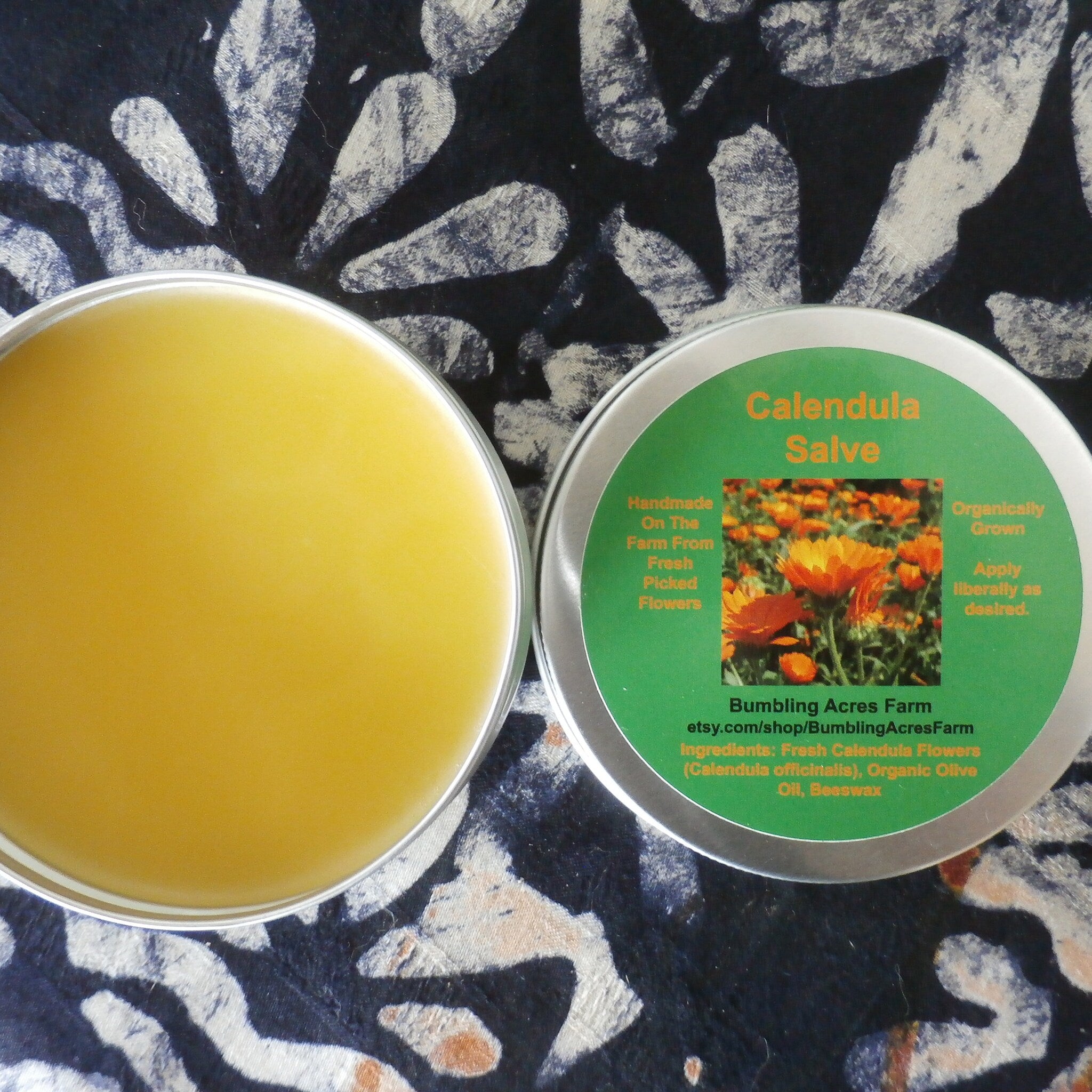 Calendula salve in metal tins, yellow salve and green label with text "Calendula Salve
