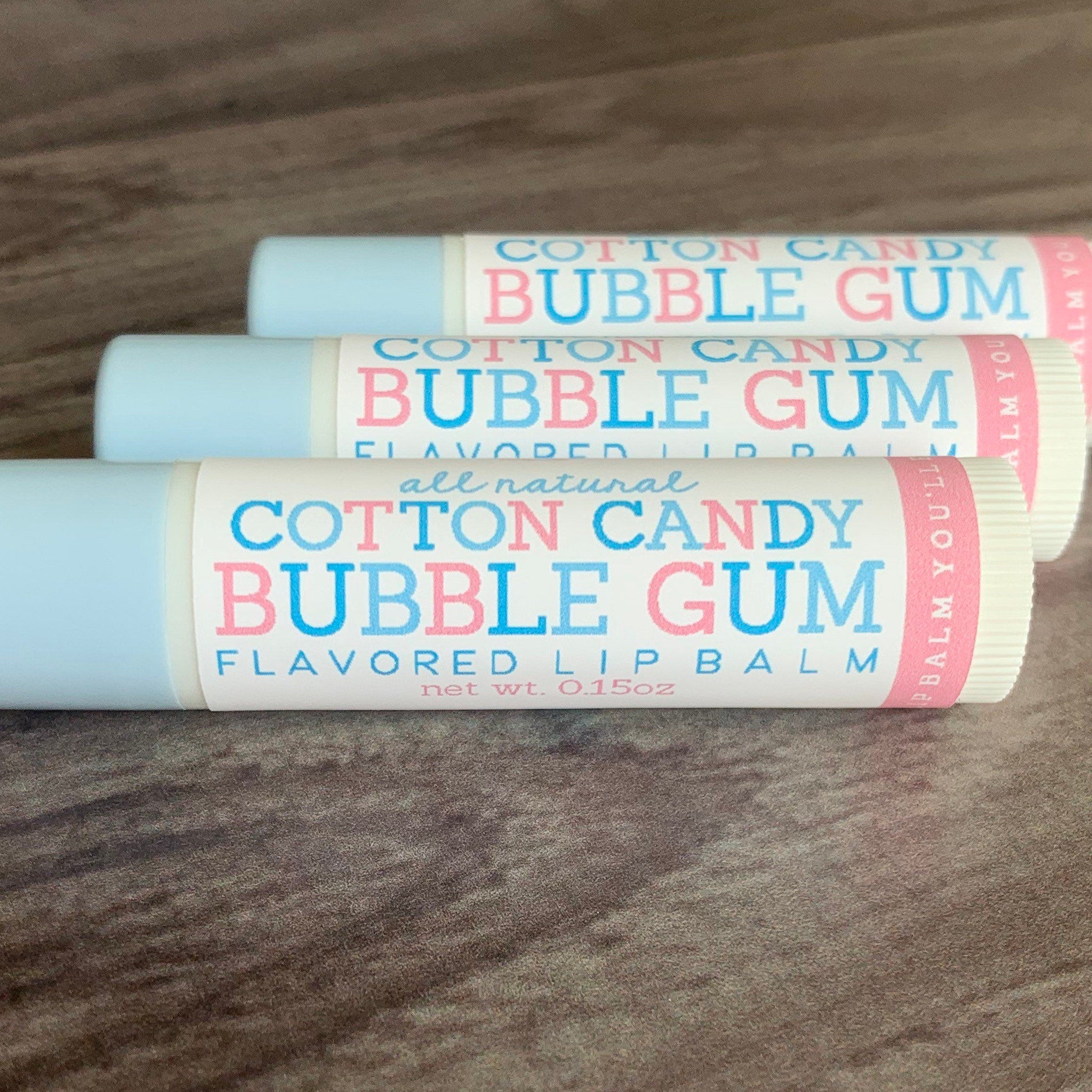 Lip balm tubes with blue and white, pink text, and Cotton Candy Bubble Gum flavor.