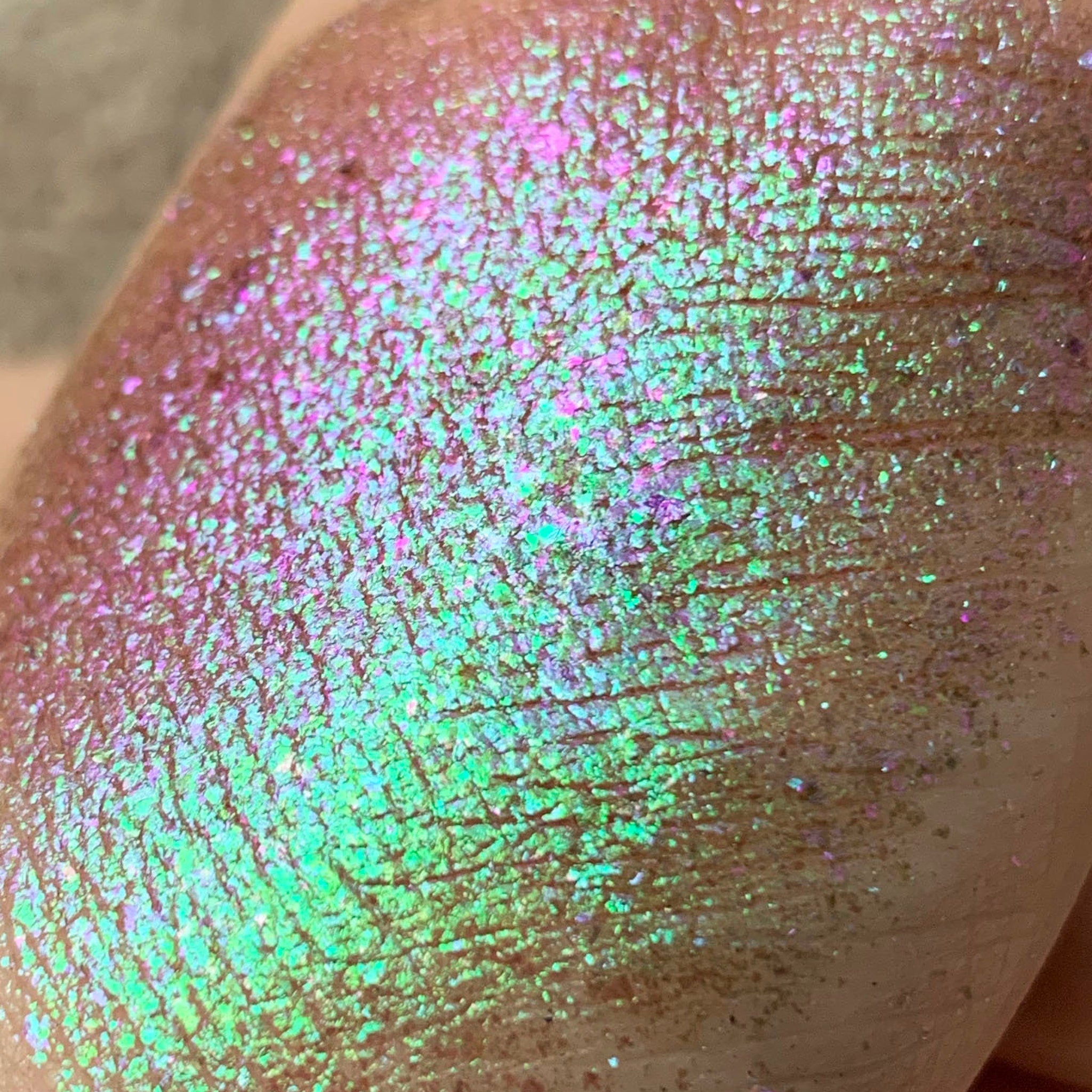 Close-up of Tala Foil Candy Eye Shadow Pigment in shade FL13, showing metallic pink shimmer texture in compact pot.