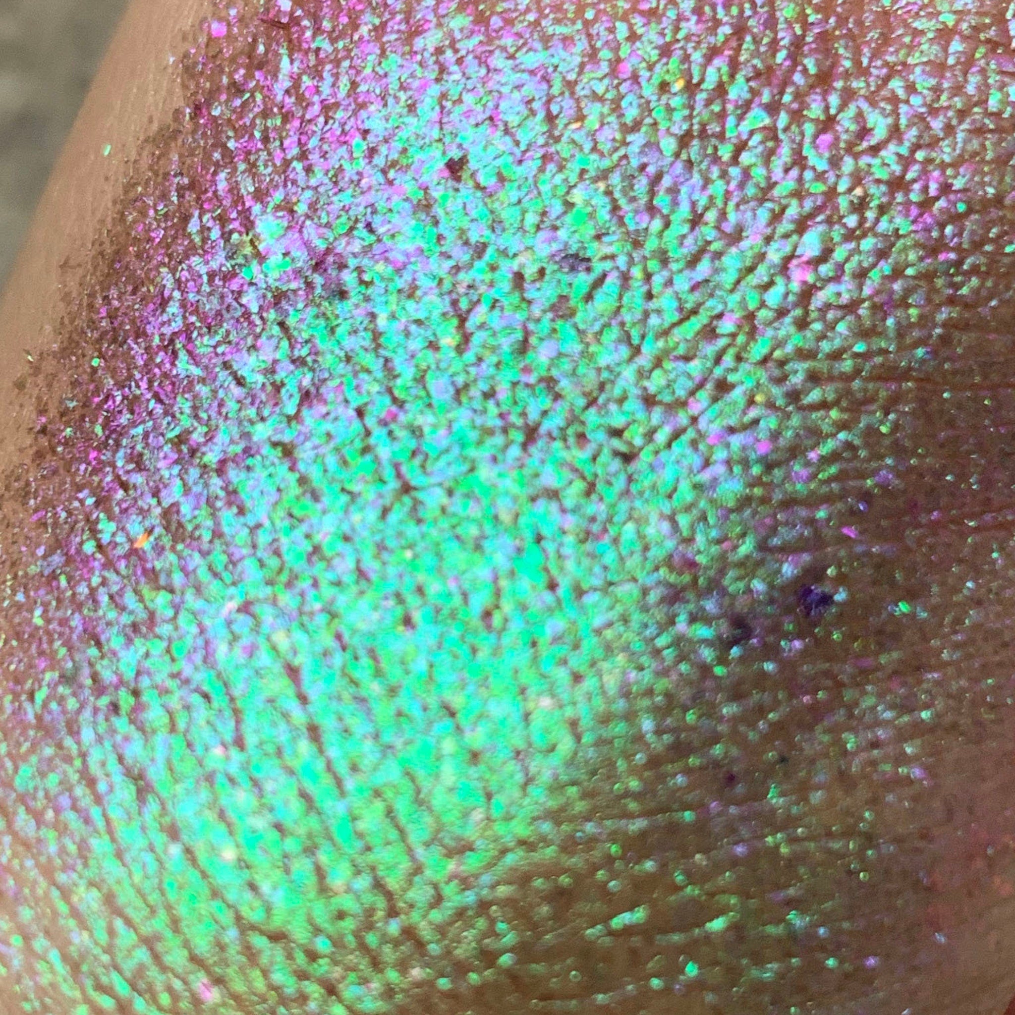 Close-up of Tala Foil Candy Eye Shadow Pigment in shade FL13, showing vibrant metallic shimmer in a small 2ml container