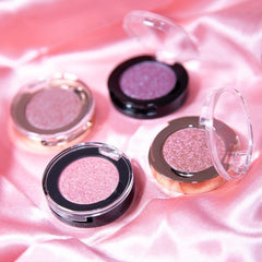 Close-up of shimmering bronze eye shadow palette with smooth, blendable powder texture