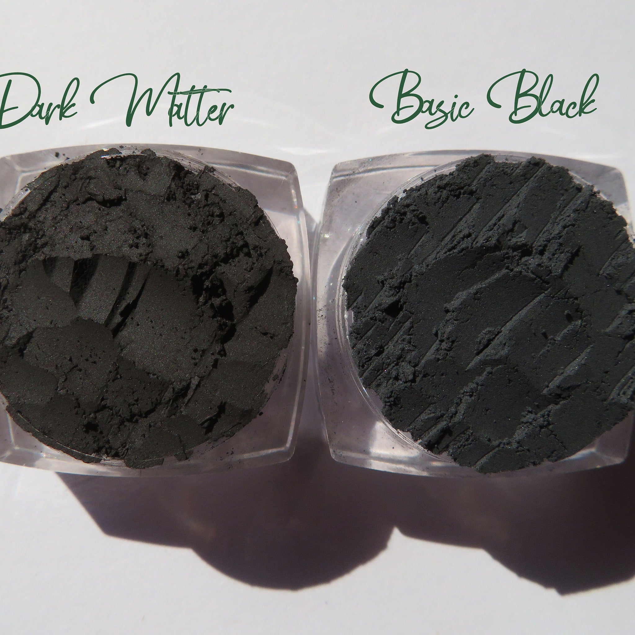 Hand applying matte black vegan eyeshadow with a blending brush onto eyelid crease