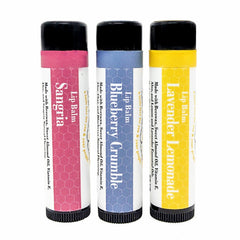 Lip balm tubes in pink, blue, and yellow with honeycomb pattern, Sister Bees brand visible