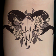 Body makeup temporary tattoo with floral deer skull design, black and gray, feminine style