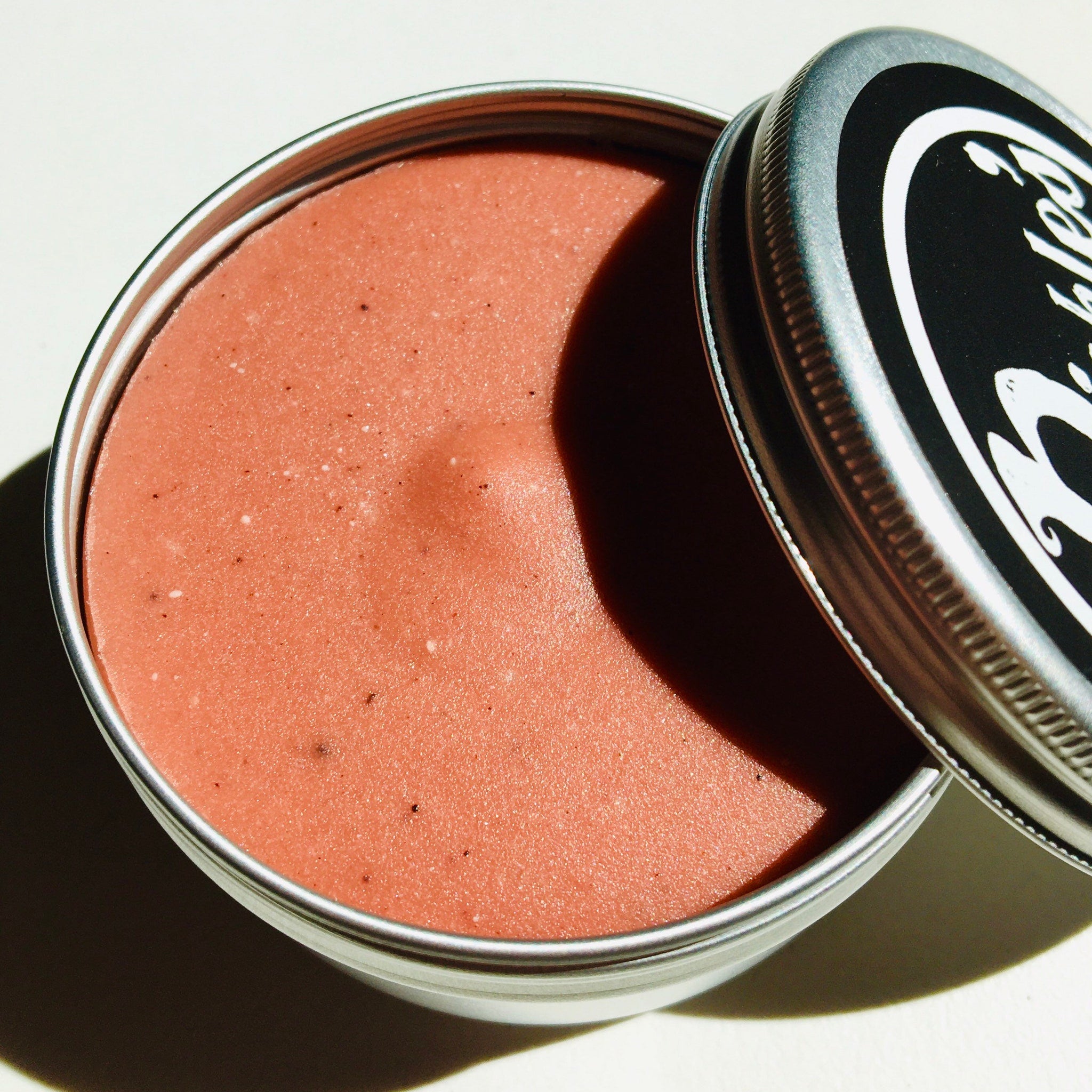 Pink cream in a silver metal tin, with black and white label visible on lid