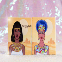 Queen Nandi Beauty 18-color eyeshadow palette with vibrant hyper-pigmented shades in warm and cool tones, rectangular black case