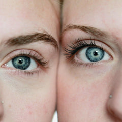 Blue eyes with dark eyelashes and brown eyebrows close up shot