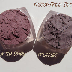 Two matte brown vegan loose powder eyeshadows in shades truffle and turtle shell with minimalist packaging.