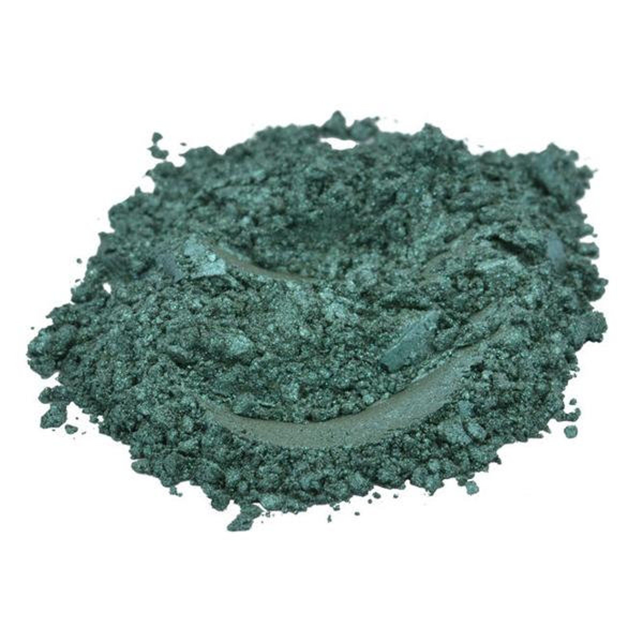 Hand applying dark stale green mica pigment powder as eyeshadow with a fluffy brush