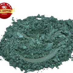 Close-up of dark stale green mica pigment powder in a cosmetic jar with shimmering metallic finish