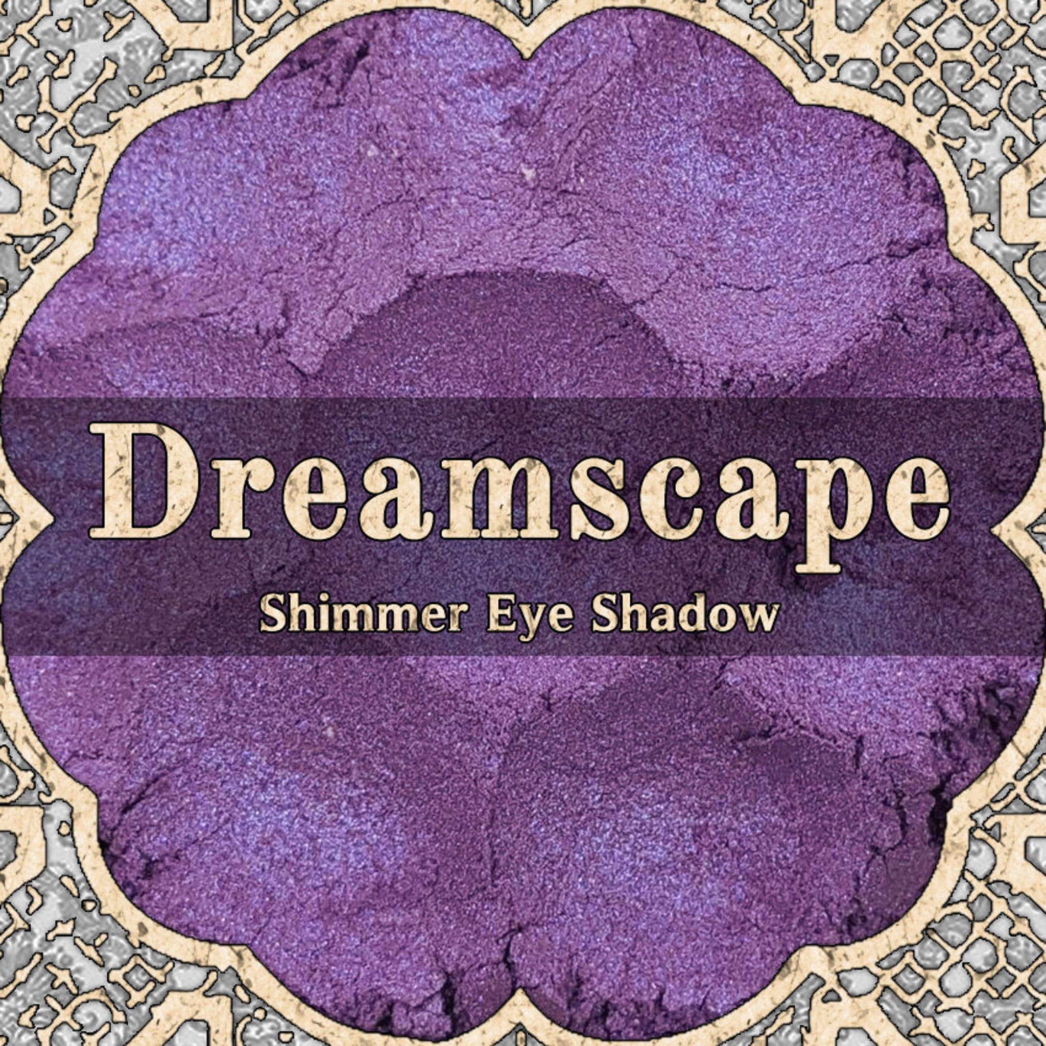 Close-up of loose powder eyeshadow in shifting purple and blue duochrome shimmer, vegan formula in small jar