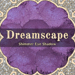 Close-up of loose powder eyeshadow in shifting purple and blue duochrome shimmer, vegan formula in small jar