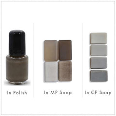 Nail polish bottle with black cap, and various soap bars in different colors