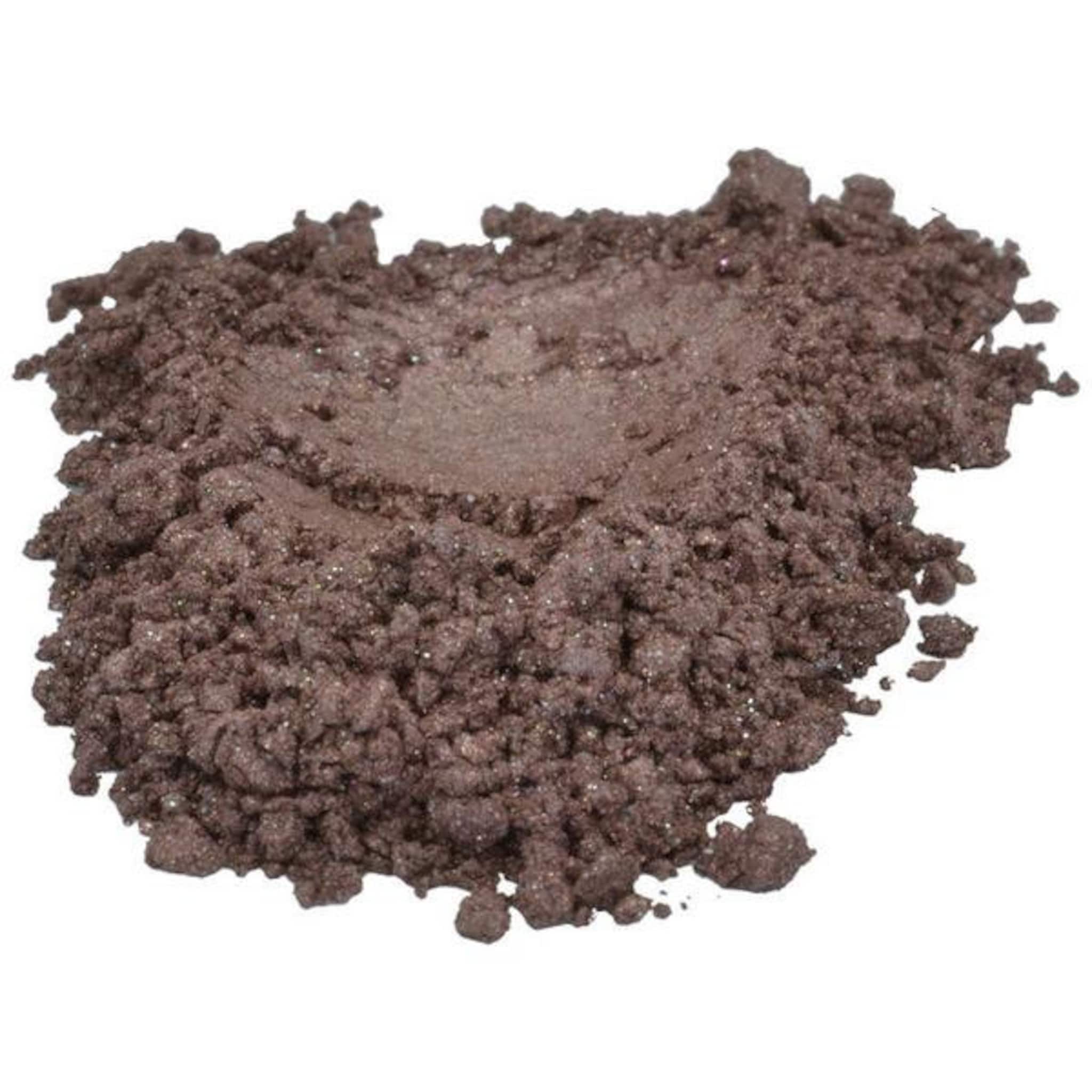 Brown eyeshadow powder with shimmer and granular texture