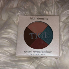 Quad eyeshadow palette with brown, red, green, and tan colors, TIGI brand name visible, in a white box