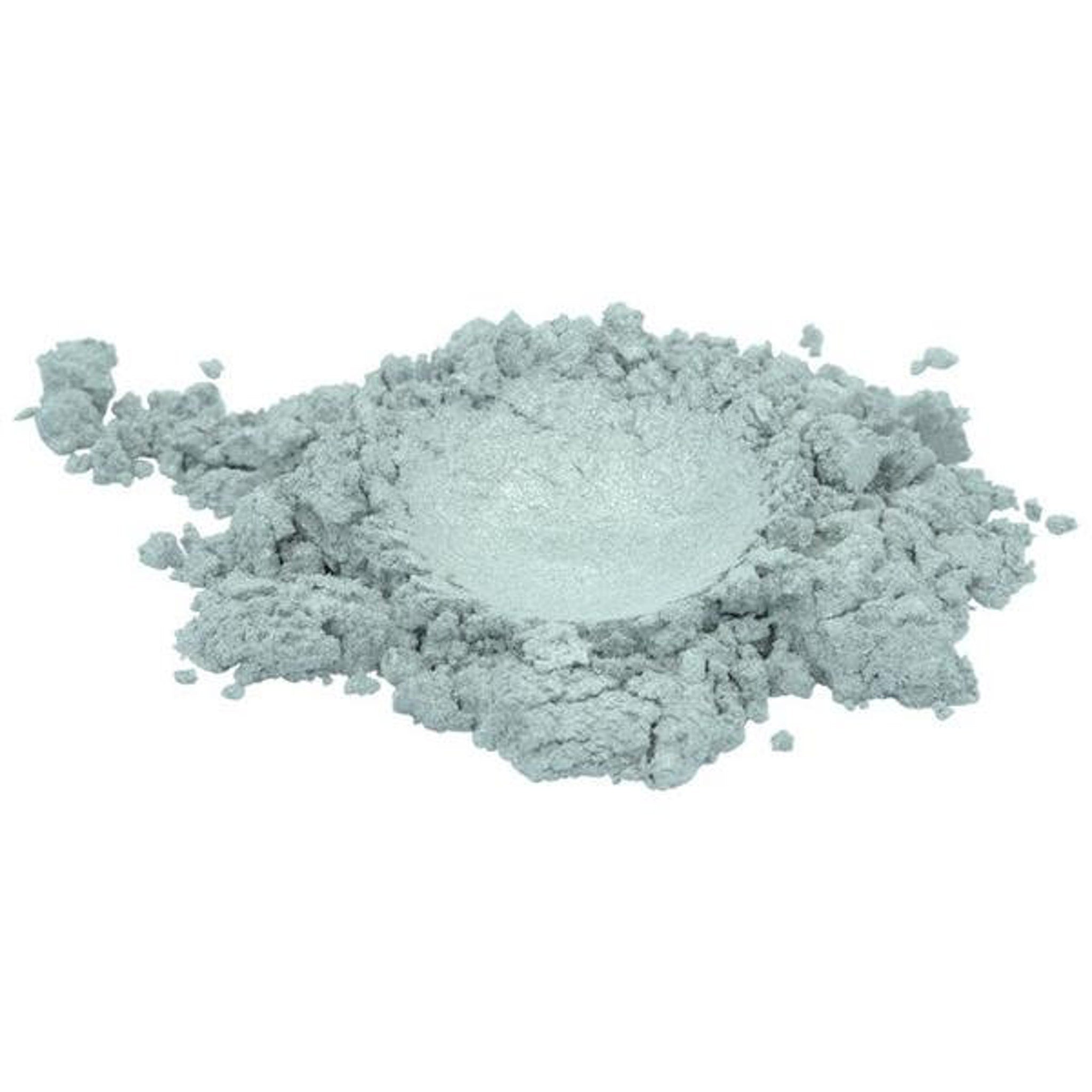 Close-up of shimmering white mica pigment powder spilling from jar with metallic sheen