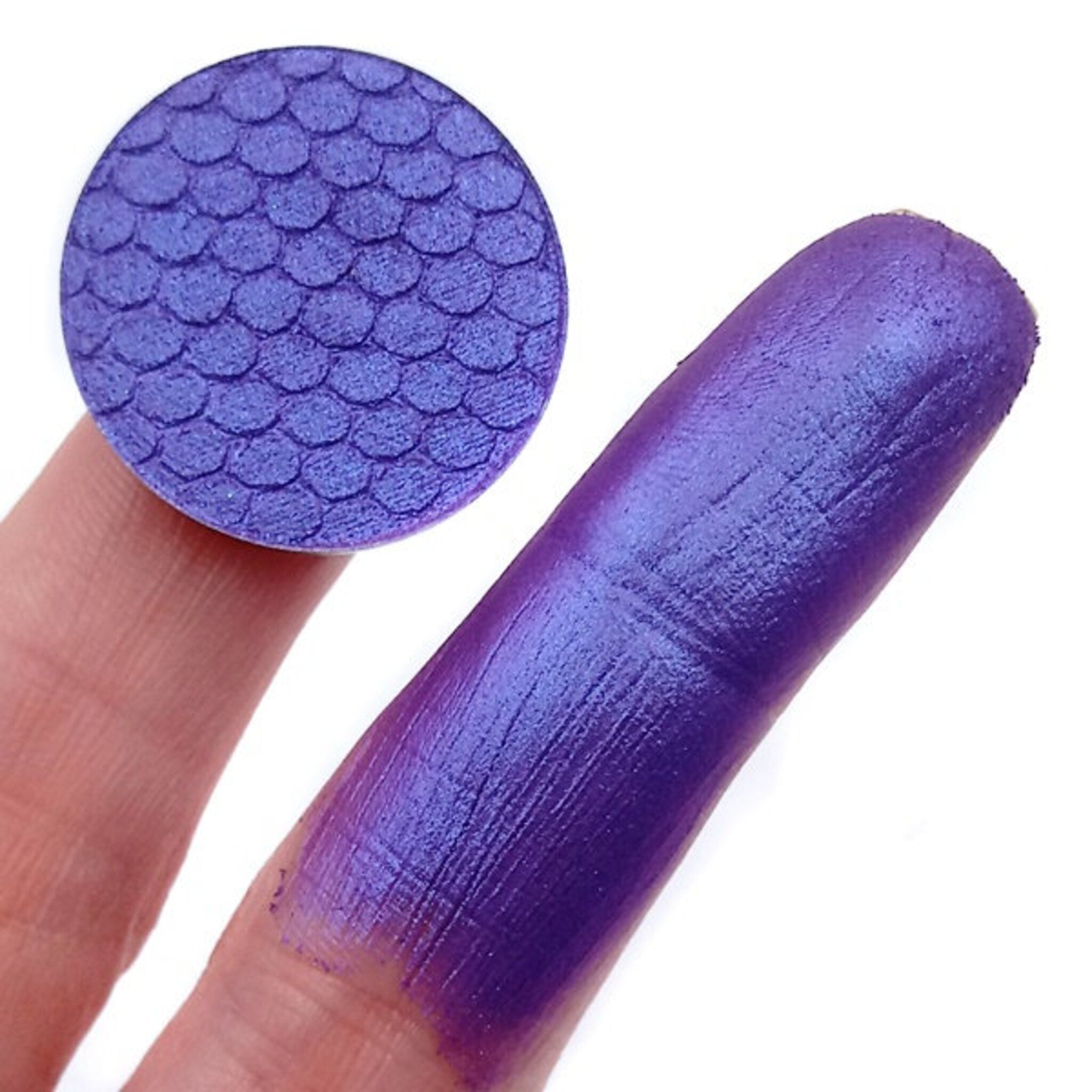 Purple and blue duochrome eyeshadow pan in sleek black compact with silver trim