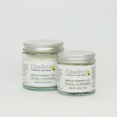 Facial cleanser jars with silver lids, glass jars, and "Flawless" branding displayed
