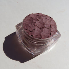 Side view of matte brown vegan eyeshadow set showing loose powder textures in truffle and turtle shell shades