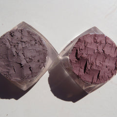 Close-up of matte brown vegan loose powder eyeshadows in truffle and turtle shell shades with soft texture