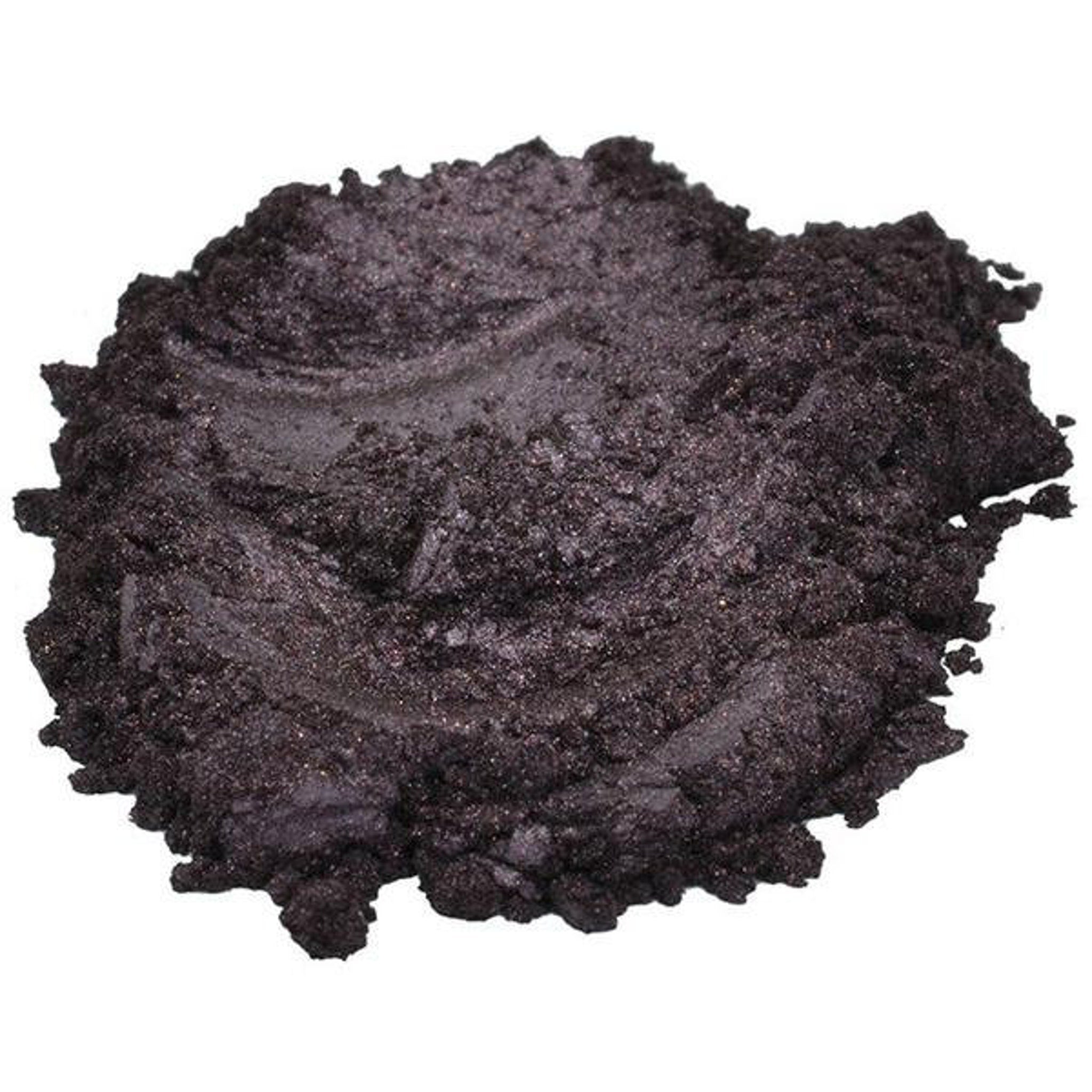 Dark purple powder with glittery texture and granular appearance on white background