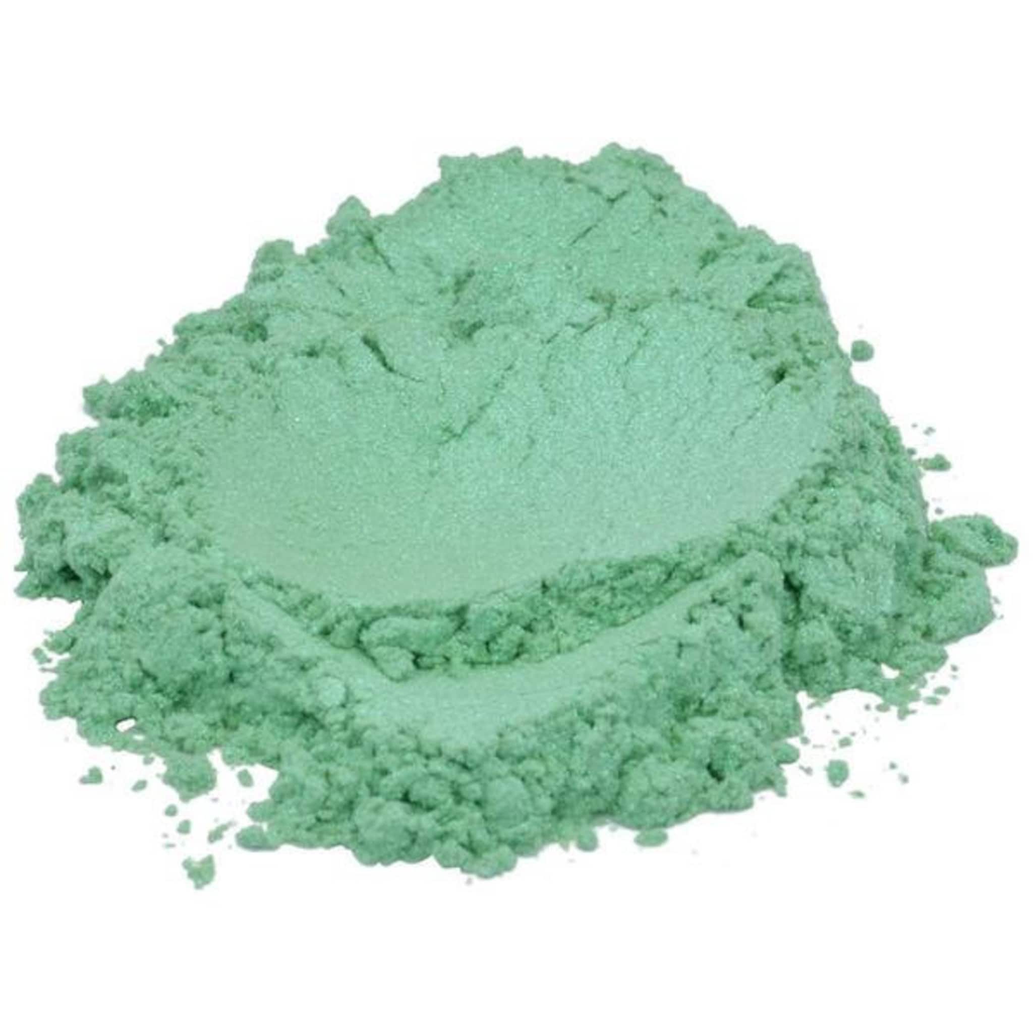 Close-up of vibrant spring green mica pigment powder shimmering in natural light with fine texture