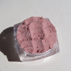 Side view of matte medium pink loose mineral eye shadow in open jar, showcasing powdery texture and vegan label