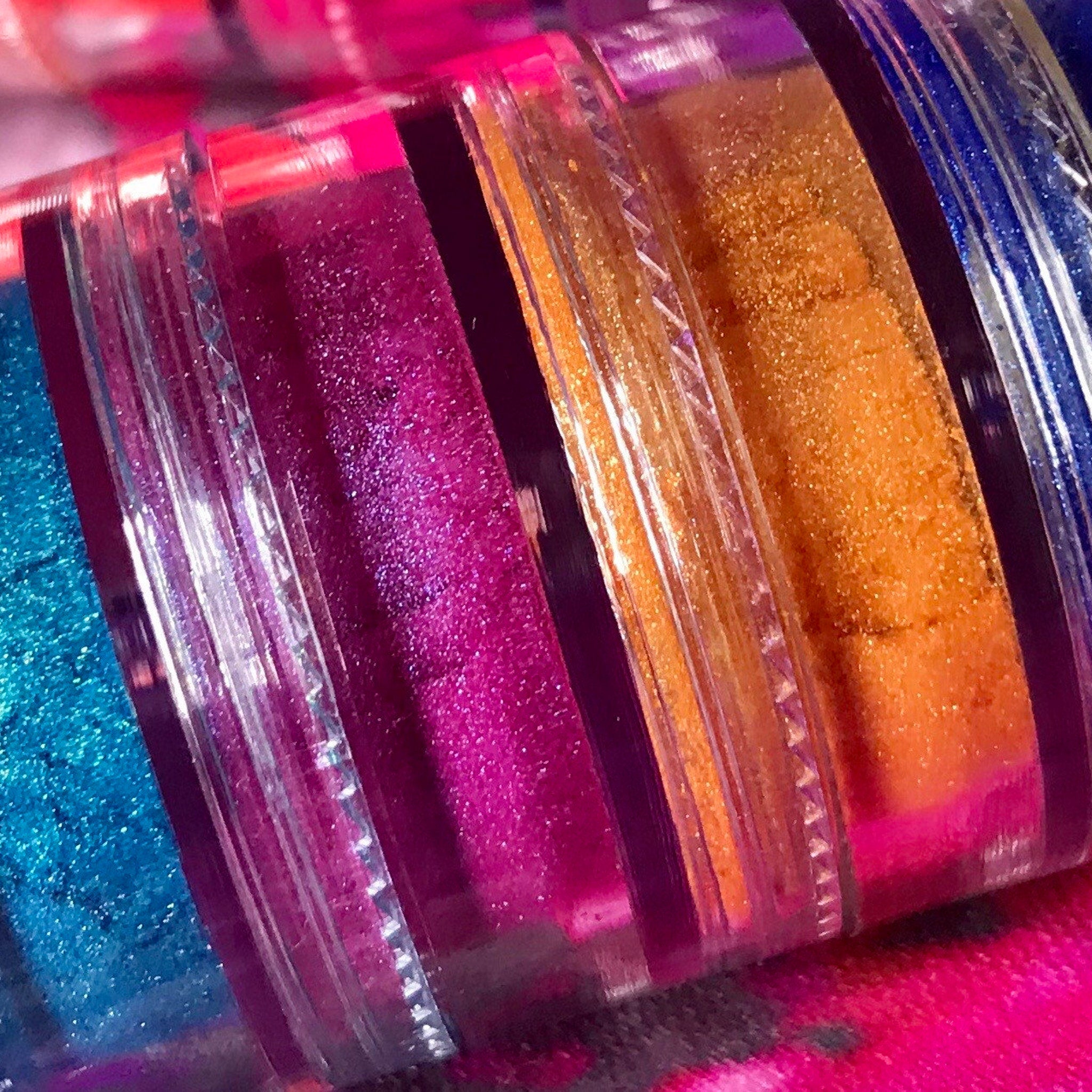Close-up of shimmery emerald green eyeshadow stack with vibrant pigment and smooth texture