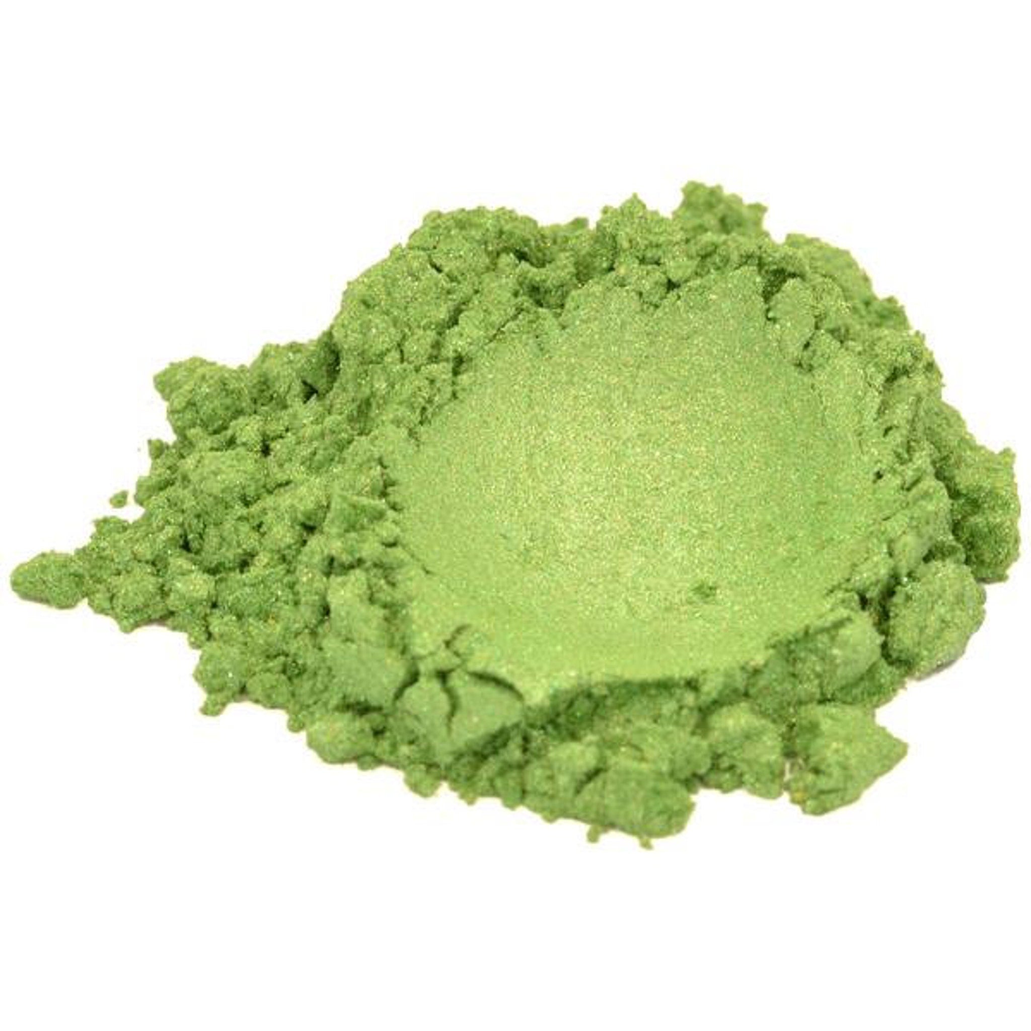 Side view of vibrant green mica powder in clear jar showing fine shimmering texture