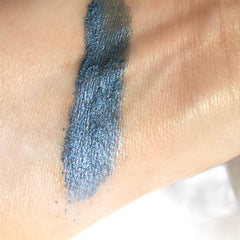 Eyeshadow swatch, metallic blue with shimmer, applied on skin