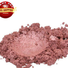 Close-up of rich Tibetan ochre red-brown mica powder in open jar with metallic shimmer